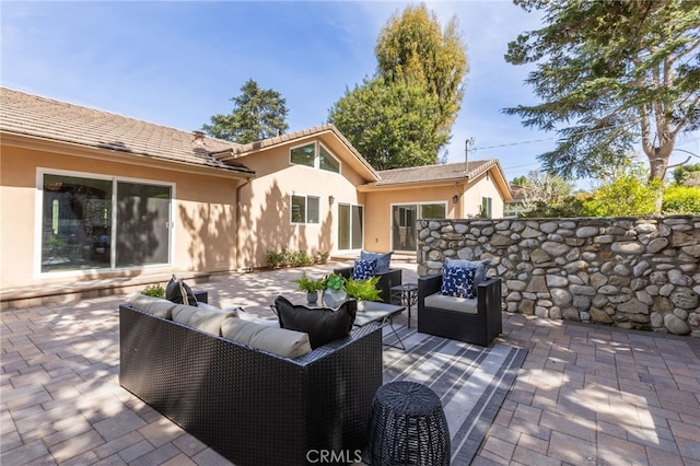 view of patio / terrace with an outdoor hangout area and fence