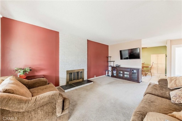 carpeted living room featuring a brick fireplace and baseboards