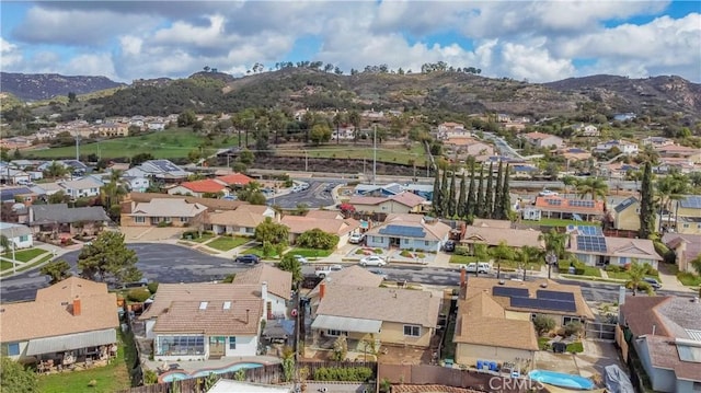 drone / aerial view featuring a residential view and a mountain view