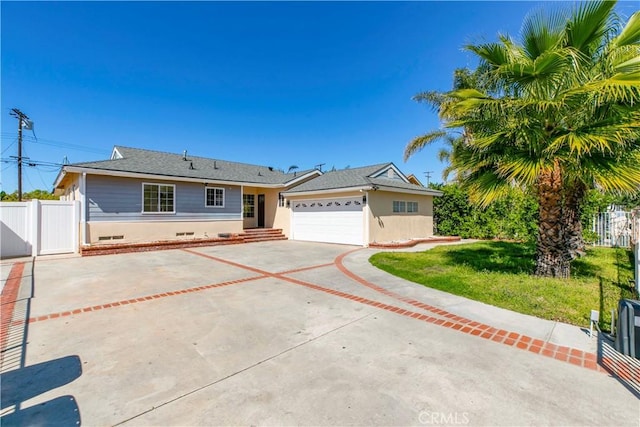 ranch-style house featuring driveway, fence, a gate, and stucco siding