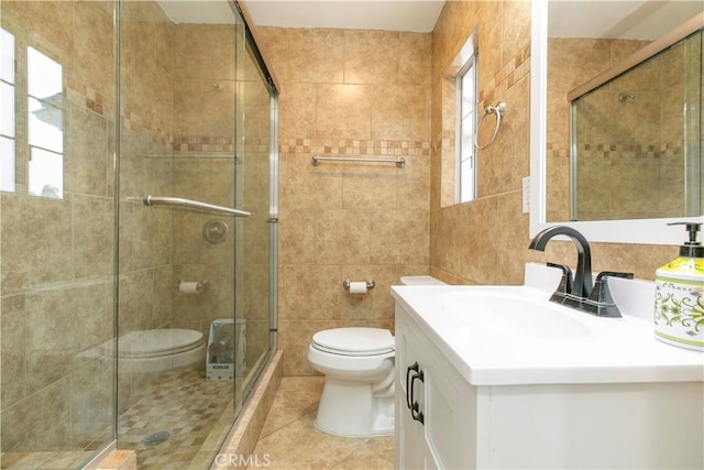 bathroom featuring a stall shower, toilet, and tile walls