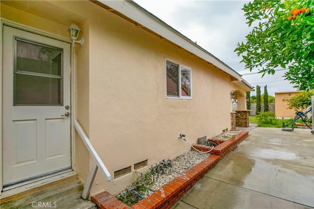 view of home's exterior with a patio and stucco siding