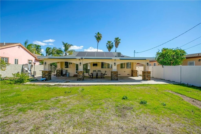 back of house with a patio, a lawn, a fenced backyard, and stucco siding