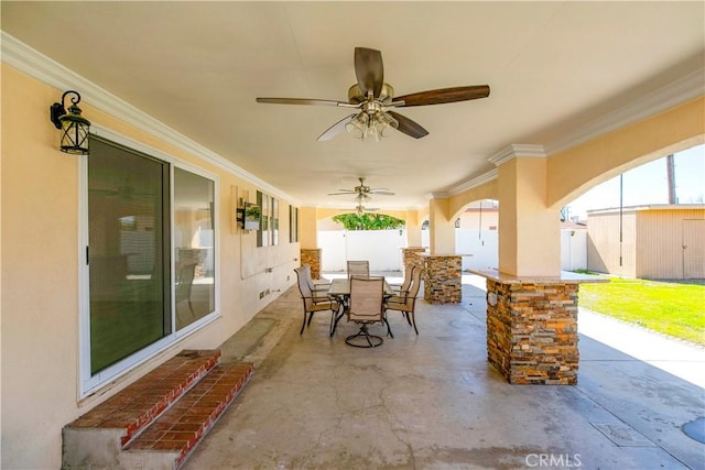 view of patio / terrace featuring a ceiling fan, outdoor dining space, and fence