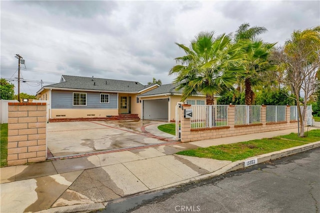 view of front of home with driveway and a fenced front yard