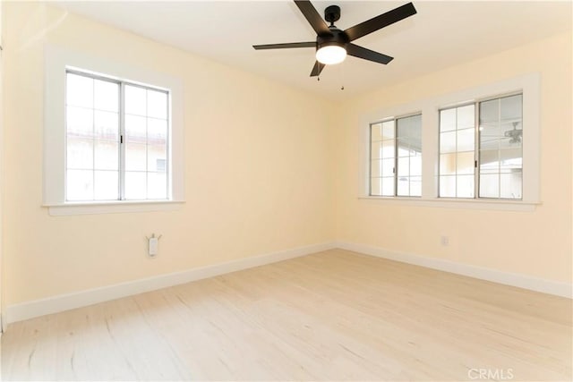 unfurnished room featuring ceiling fan, wood finished floors, and baseboards