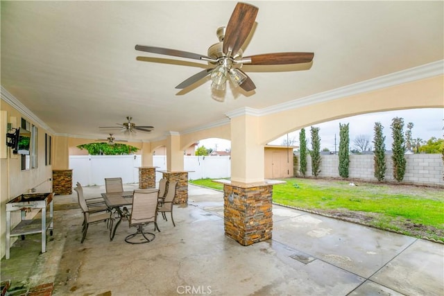 view of patio featuring a ceiling fan, outdoor dining space, and a fenced backyard