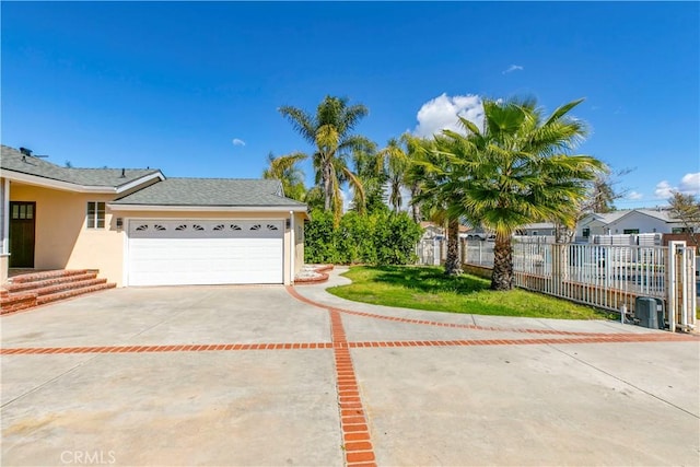 view of front of house featuring a garage, stucco siding, driveway, and fence