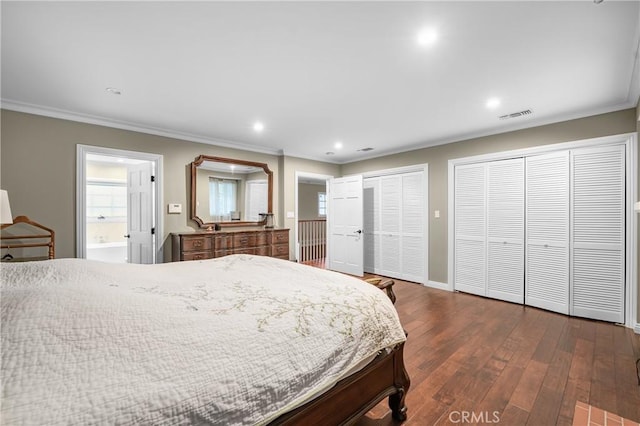 bedroom with recessed lighting, dark wood-type flooring, visible vents, multiple closets, and crown molding