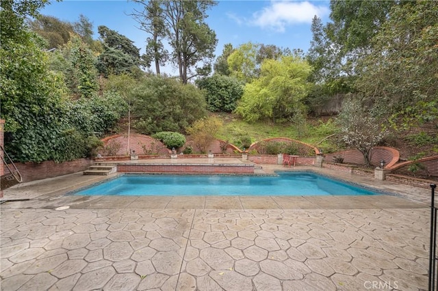 outdoor pool featuring a patio