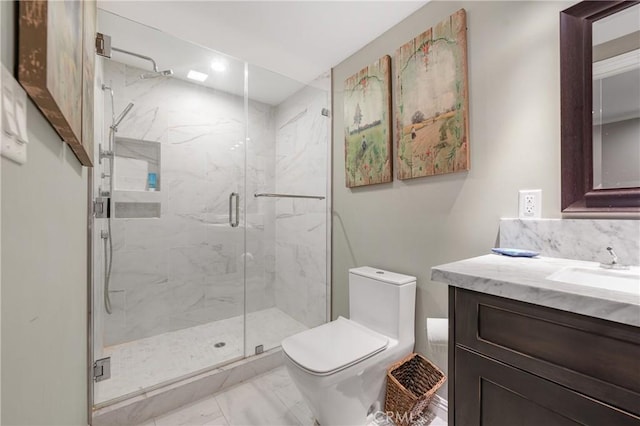 bathroom with marble finish floor, a marble finish shower, vanity, and toilet