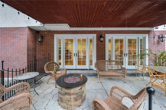 view of patio featuring a fire pit and french doors