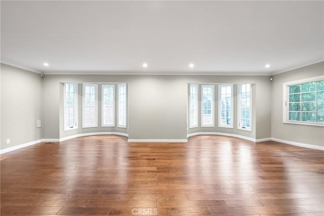 unfurnished living room featuring baseboards, wood finished floors, and recessed lighting