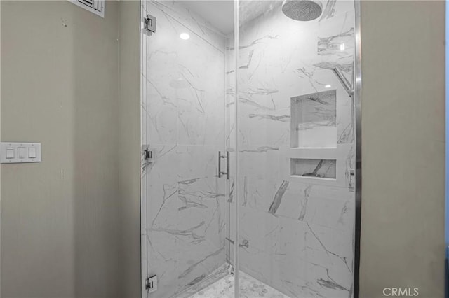 full bath with a marble finish shower