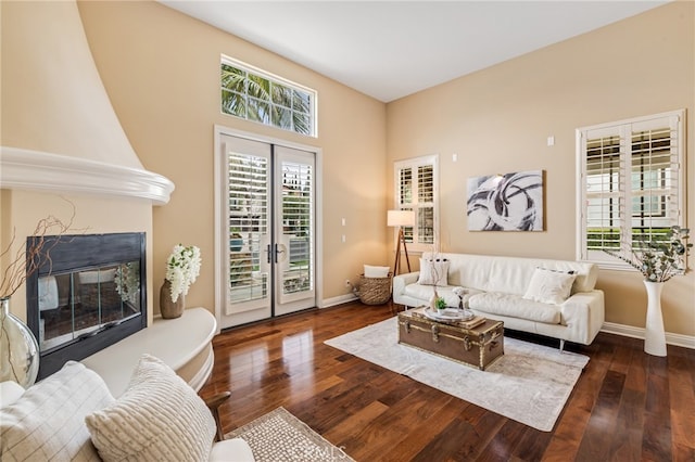 living area featuring french doors, wood-type flooring, and baseboards