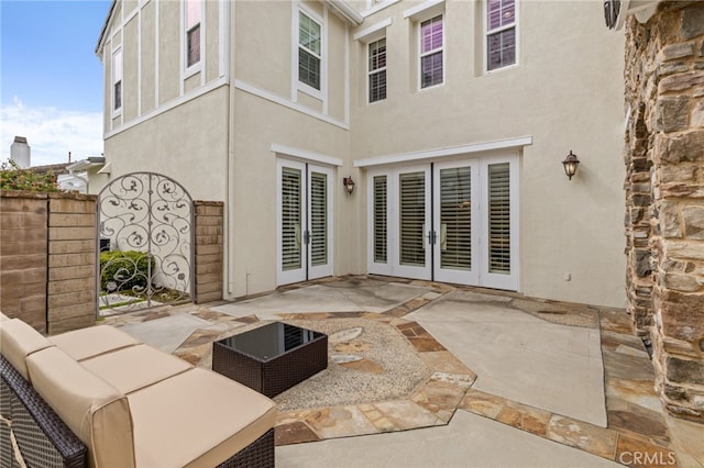 rear view of property with an outdoor hangout area, a patio, fence, and stucco siding