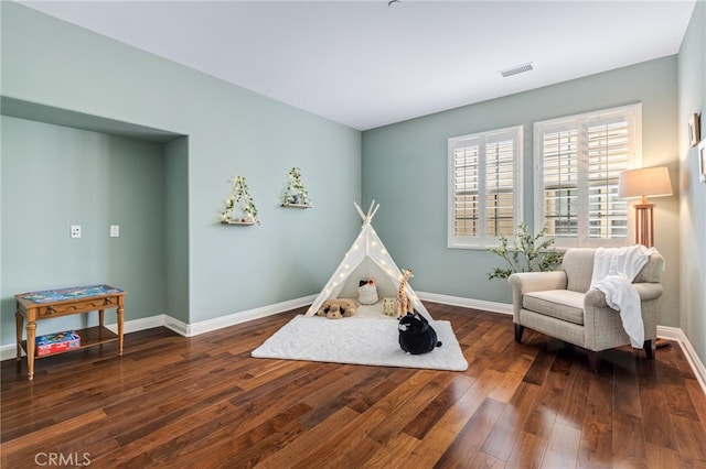 rec room featuring hardwood / wood-style floors, visible vents, and baseboards