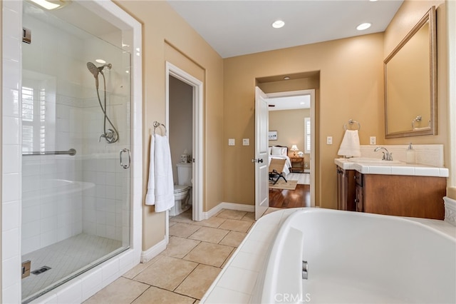 bathroom featuring toilet, a shower stall, connected bathroom, and vanity