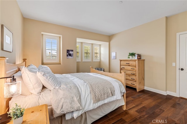 bedroom featuring dark wood-style floors and baseboards