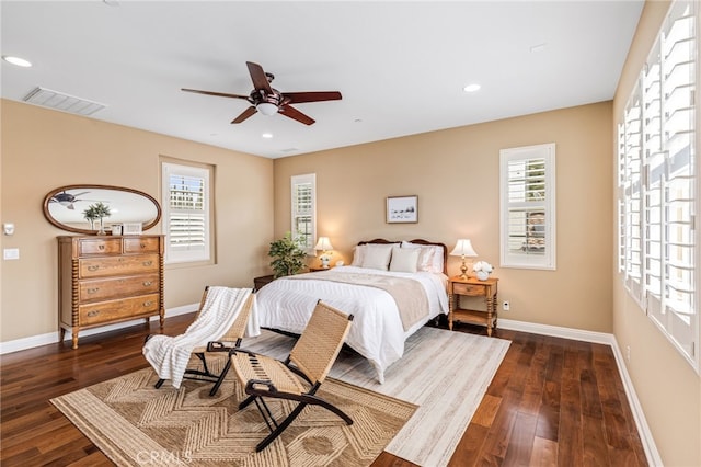 bedroom featuring baseboards, multiple windows, and visible vents