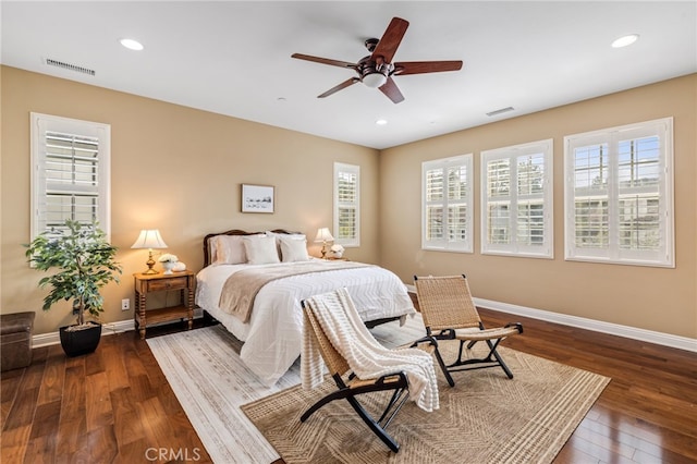 bedroom with baseboards, visible vents, and hardwood / wood-style floors