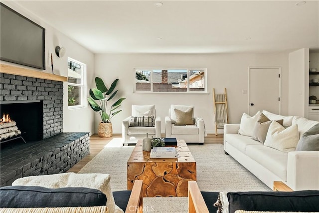 living area with a fireplace and wood finished floors