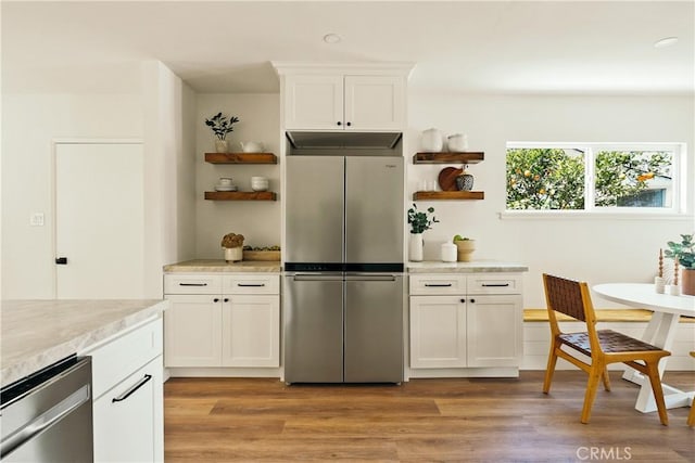 kitchen featuring appliances with stainless steel finishes, light wood-type flooring, white cabinetry, and open shelves