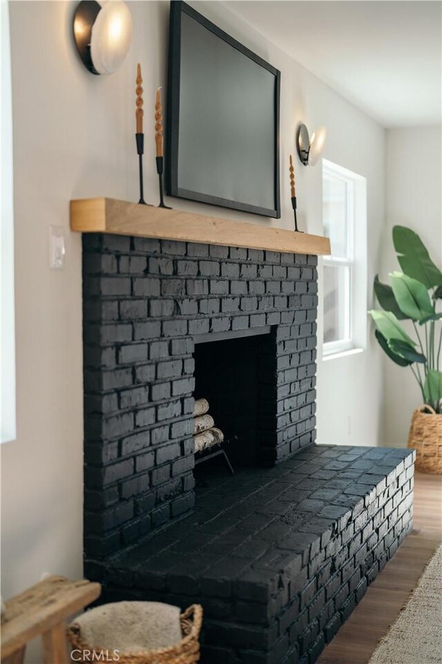 room details with a fireplace and wood finished floors