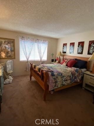 bedroom featuring carpet and a textured ceiling