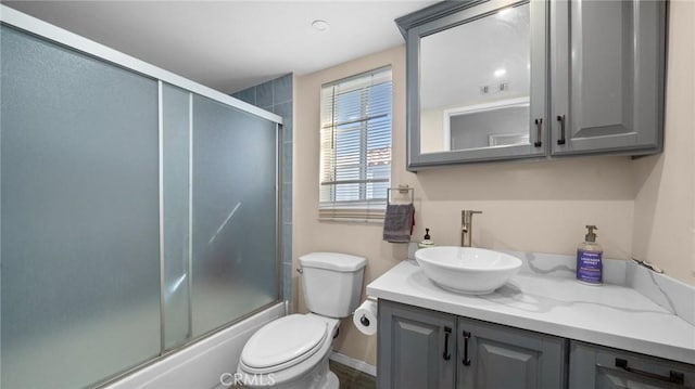 full bath featuring visible vents, shower / bath combination with glass door, vanity, and toilet