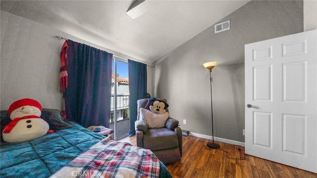 bedroom featuring visible vents, vaulted ceiling, baseboards, and wood finished floors