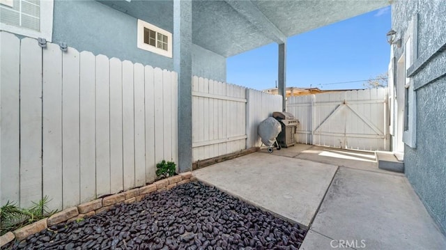 view of patio / terrace with a fenced backyard and a grill