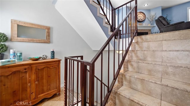 staircase with a fireplace