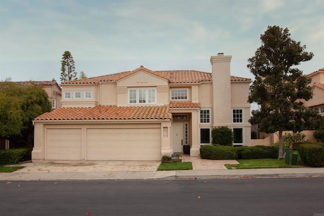 mediterranean / spanish-style home with a chimney, stucco siding, a tile roof, and a garage