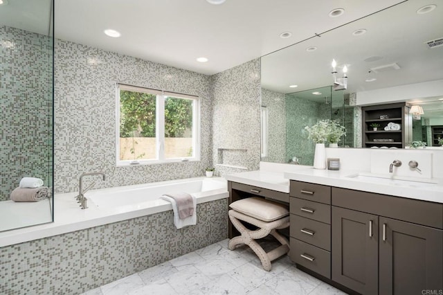 full bathroom featuring a tile shower, recessed lighting, a bath, marble finish floor, and vanity