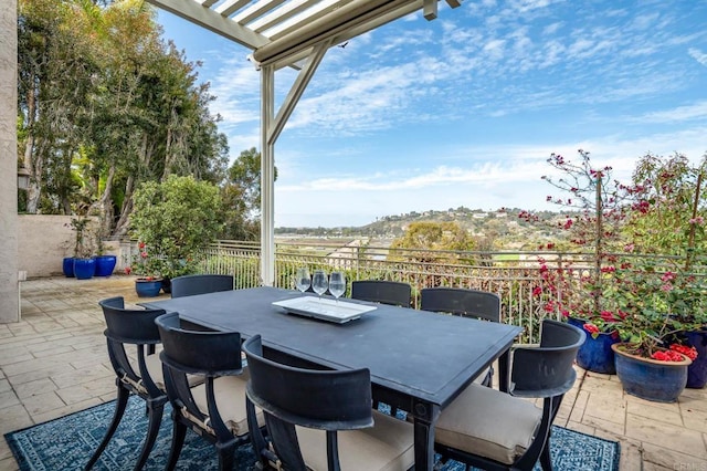 view of patio featuring outdoor dining area, fence, and a pergola