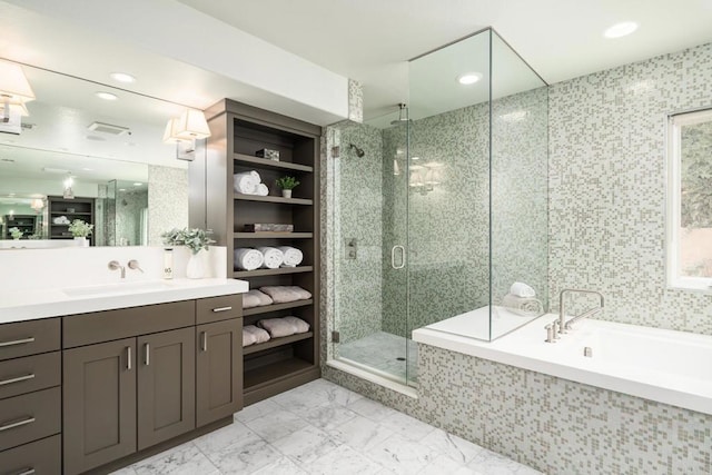 bathroom with marble finish floor, a stall shower, vanity, and a bath