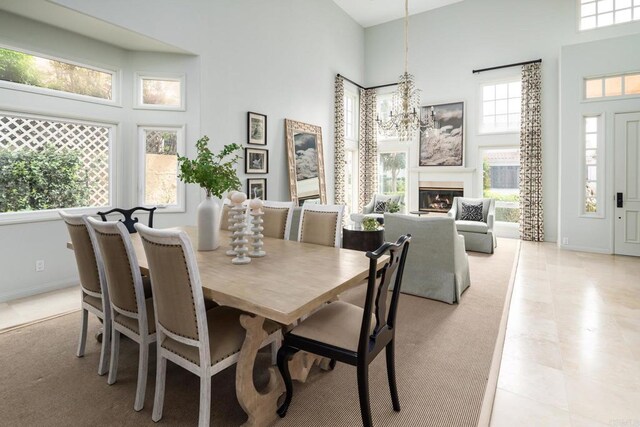 14730 Caminito Porta Delgada, Del Mar, CA 92014 - dining area featuring a high ceiling, plenty of natural light, a chandelier, and baseboards
