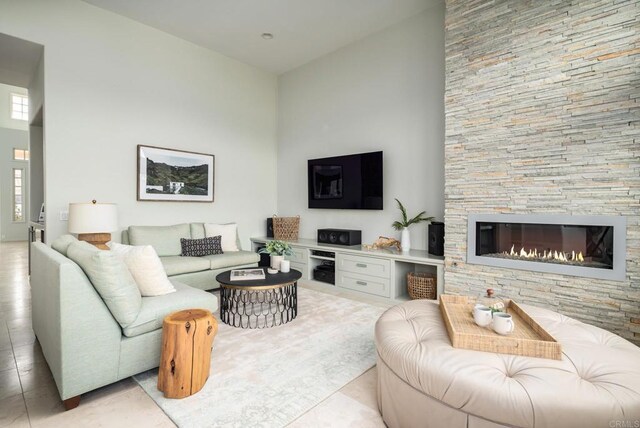 14730 Caminito Porta Delgada, Del Mar, CA 92014 - living area with a towering ceiling, a stone fireplace, and light tile patterned floors