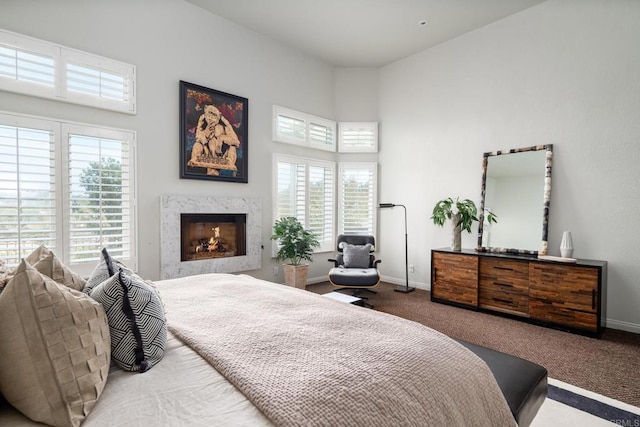 14730 Caminito Porta Delgada, Del Mar, CA 92014 - carpeted bedroom featuring multiple windows, baseboards, a high end fireplace, and a high ceiling