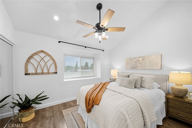 bedroom featuring lofted ceiling, ceiling fan, baseboards, and wood finished floors