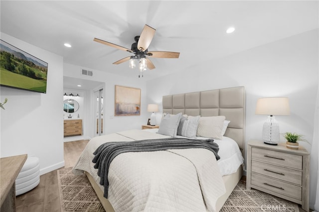 bedroom with visible vents, connected bathroom, ceiling fan, light wood-style floors, and recessed lighting