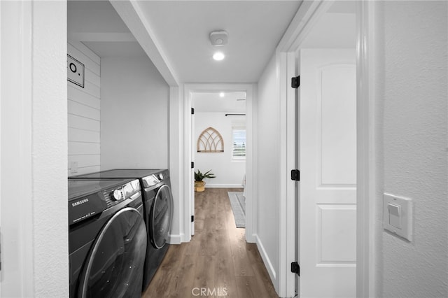 washroom featuring washer and dryer, dark wood-style flooring, and baseboards