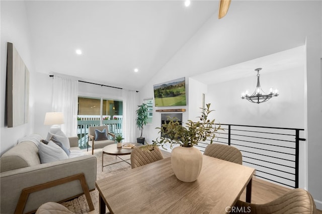 dining area with a chandelier, recessed lighting, high vaulted ceiling, and wood finished floors