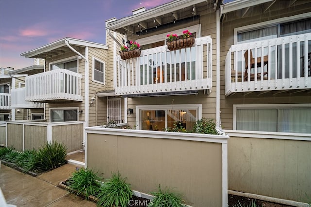 property at dusk featuring a fenced front yard