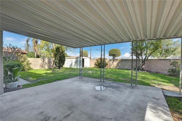 view of patio / terrace with an outdoor structure and a fenced backyard