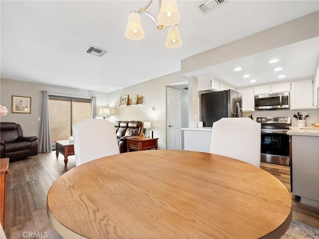 dining area featuring wood finished floors, visible vents, and recessed lighting