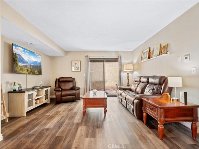 living area with wood finished floors and baseboards