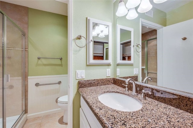 full bath featuring visible vents, toilet, a stall shower, wainscoting, and tile patterned flooring