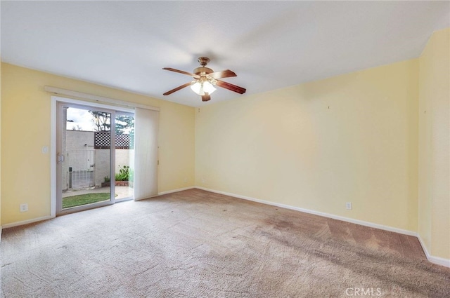 spare room with carpet, ceiling fan, and baseboards